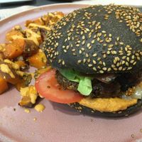 Burger with calçots and romesco and sweet potato fries at Väcka in Barcelona