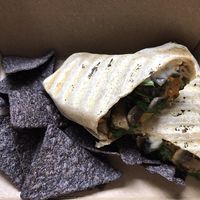 Vegan breakfast wrap with side of blue corn chips. Delicious and filling! at Healthy on Lark in Albany