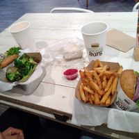 Shroom burger with zesty lemon broccoli, mustang relish burger with seaweed fries and a half eaten delicious cheesecake at VeganBurg in San Francisco