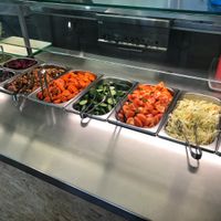 Toppings you can add to your falafel pita yourself, including tahina sauce, mango sauce, veggies, pickles, coriander sauce, spicy sauce, chickpea salad, onions, etc.  at Maoz - Albertcuypstraat in Amsterdam