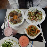 baked potatoes with skin and salt + delicious sauce, homemade tortilla chips and guacamole, fresh bruschetta, vegan pizza, milkshake and fresh juice.  at The Mantraa in Barcelona