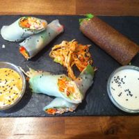 Power Rolls and Rawtastic Wrap with spicy almond sauce and creamy saue and a serving of kimchi at Rawtastic in Berlin