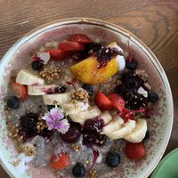 Soaked oats, quinoa and chia with poached pear and fresh fruit.   at Blendlove in Southport
