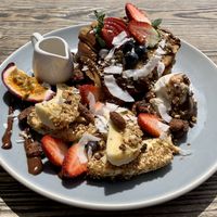 Snickers Pancakes with chocolate and caramel date sauces, maple syrup and seasonal fruits at Blendlove in Southport