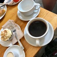 Americano with oat milk, vegan chai cupcake plus a vegan chocolate cupcake. at Cafe Mbriki in Leicester