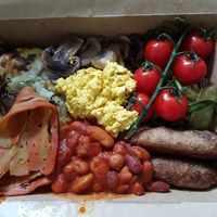 Wallflower Breakfast comes with: Bubble & squeak, fried mushrooms, scrambled tofu, mixed greens, on the vine tomatoes, facon, mixed baked beans, 2 vegan sausages, "buttered" bread. at The Wallflower Cafe in Herne Bay