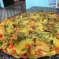 Pizza de queijo de batata, com tomate confit, pimenta biquinho e berinjela empanada  at Cozinha Divina in Olinda
