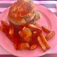 Open faced chick pea burger over pita with spinach, red onion and tomato. Served with veganaise and your choice of fries. at Sunnyside Cafe in Sarasota