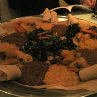 Vegetarian platter for 4 people : injera bread, split peas (yekik alicha), potatoes, carrots and cabbage (yatakelt watt), spinach (gommen) and lentils in spicy sauce (yemesser watt). Small salad in the centre.

Very good choice. at Le Nil Bleu in Montreal