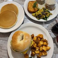 Breakfast bagel Sandwich with potatoes, biscuits and gravy with tofu scramble and hash browns and a side of pancakes. Amazing!   at New Leaf Cafe in Tampa