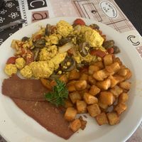 Tofu scramble with vegetables, home fries, and life light bacon at New Leaf Cafe in Tampa