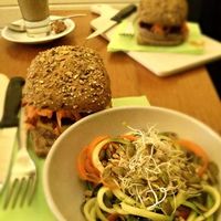 Vegan burger-sandwich with melted cheese and salad on side.  at Kafe PUUR in Antwerpen