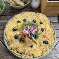 Savoury pancake with tomato, mushrooms, onion, olives and vegan cheese at Pfefferminzje in Koblenz