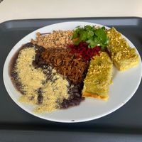 Daily menu combination with beans, tofu, brown rice, corn cake and salad at Escolha Natura in Lisbon