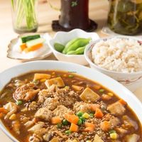 Mar Po Tofu Set, consisting of Tofu, Yamabushi Take (Monkey head Mushrooms) fresh vegetables cooked with healthy spices and black miso. White or brown rice, fresh Soya beans and pickled vegetables. A choice of coffee or tea. at Seven Bells Cafe in Tachikawa