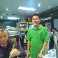 Chin, the owner, with some other guy who squeezed into the shot with his green chopsticks at Inala Vegan Restaurant in Inala