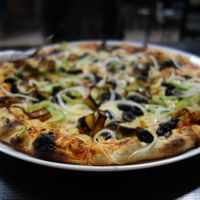 Kami Express Pizza (vegan) with falafel, aubergine, green pepper, olives, onions, and vegan cheese at Kami Express in Saarbrucken