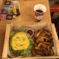 Spicy burger (yellow bun) with plenty of fries  at Flower Burger - Viale Vittorio Veneto in Milan