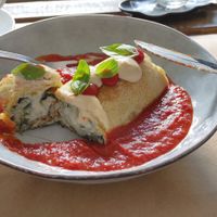 Crespella: Baked crepe filled with spinach and almond ricotta cheese; served with tomato sauce, and cashew cheese drops at BuenaVida Vegan in Tenerife