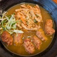 Curry udon with vegetable tempura and soy nuggets at Mimikou in Kyoto