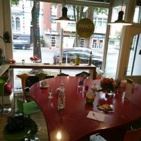 The lovely central big table with dog pillow below at Fancy Foods in Wuppertal