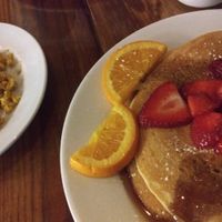 Vegan pancakes with strawberries, tofu scramble and veggie sausage at Backwater in Melbourne