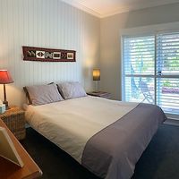 This was our bedroom. It was very cozy and comfortable. My favourite features were the ceiling fan and the glass door leading to a garden seating area with a lovely hanging chair. at The Beet Retreat in Cooroibah
