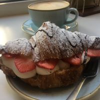 Filled croissant with vegan whip cream, strawberries, chocolate and an oat latte  at Kaf in Copenhagen