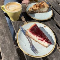Flat white with latte art being demolished by the wind, pecan cheesecake and New York cheesecake.  at Kaf in Copenhagen