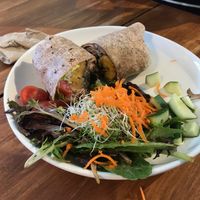 Cuban burrito (whole wheat wrap, black bean sofrito, lettuce, organic basmati brown rice, sweet plantains , tomatoes, avocado, cilantro aioli sauce, served with salad) at Love Life Cafe in Miami