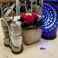 Different colored lamps on each table at dinnertime, live flowers at Veggiezz - Am Salzgriess in Vienna