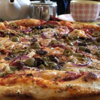 Vegan olive & red onion stonebaked pizza  at The Veggie Cafe in Ilkley