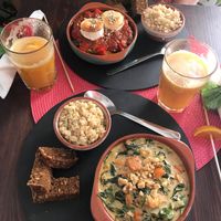 Spanish Pisto up top (vegetarian) and a Squash & Spinach soup (vegan) in front of me. Both delicious. at Dona Flor Cafe in Cascais