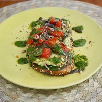 Tostada de aguacate, tomate cherry  y pesto at Dona Flor Cafe in Cascais