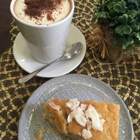 Coconut cake with Hot chocolate  at Dona Flor Cafe in Cascais