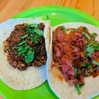 a couple of tacos. tinga taco on the right is made with various vegetables. the oat chorizo taco is made with oats and mushrooms. both very tasty  at Veggie Table in Puerto Vallarta