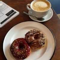 blueberry pistacchio and nougat donuts with a cafe latte at Brammibal's Donuts - Maybachufer in Berlin