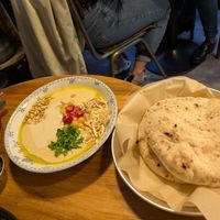 Hummus and pita with zhug at La Hummuseria in Madrid