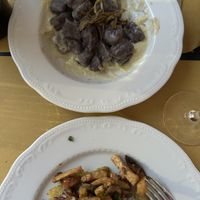 Purple gnocchi at top.  Mushroom/seitan or potato cake at bottomm  at Mezzaluna in Turin