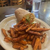 Burrito (other half already eaten) with sweet potato fries  at East West Cafe in Santa Rosa