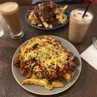 Vegan bolognaise and chips with an oat iced latte   at Maggie Mays in Belfast