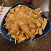 Vegan cheesy chip with curry sauce. at Maggie Mays in Belfast