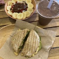Oatmeal with extra chocolate peanut butter, panini with avocado and hummus and a smoothie with cacao, dates, peanut butter and banana at Milk Away in Sevilla