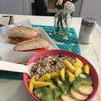 açai bowl with tomato and olive oil sandwich  at Milk Away in Sevilla