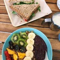 Mixed fruit acai bowl and a rocket, avocado and tomato sandwich!  at Milk Away in Sevilla