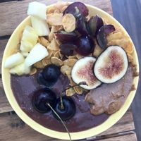 Açaí bowls with mixed fruit, almond butter and gluten free cornflakes.  at Milk Away in Sevilla