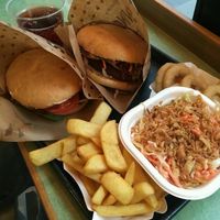 Burger, coleslaw, oniom rings and fries at Swing Kitchen - Operngasse in Vienna