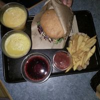 Cheeseburger, fresh orange juice, fries, organice ketchup and cherry juice. at Swing Kitchen - Operngasse in Vienna