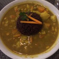 Spicy potato curry with red rice at Jalus Vegan Kitchen in Hanoi