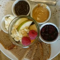 sweet plate with cream cheese, homemade nutella, peanutbutter, fruit preserves, fresh fruit, cinnamon and bread  at Wesola Cafe in Krakow